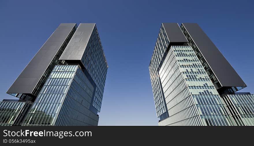 Urban view at modern glass building with blue sky. Urban view at modern glass building with blue sky