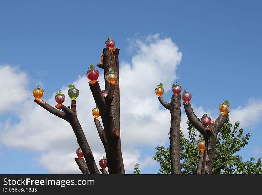 Handmade colored glass apples and put in tree