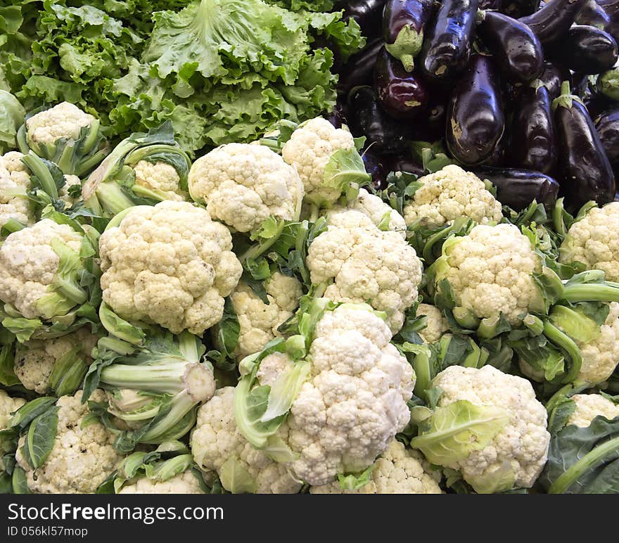 Fresh ripe cauliflower and eggplant for sale in a market. Fresh ripe cauliflower and eggplant for sale in a market