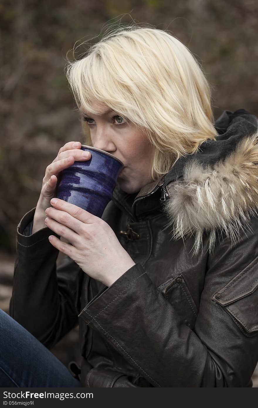 Portrait of a blonde woman holding a cup of coffee. Portrait of a blonde woman holding a cup of coffee.