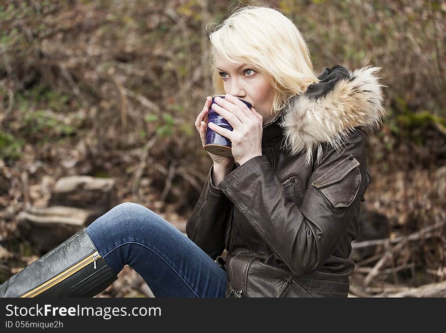 Portrait of a blonde woman holding a cup of coffee. Portrait of a blonde woman holding a cup of coffee.