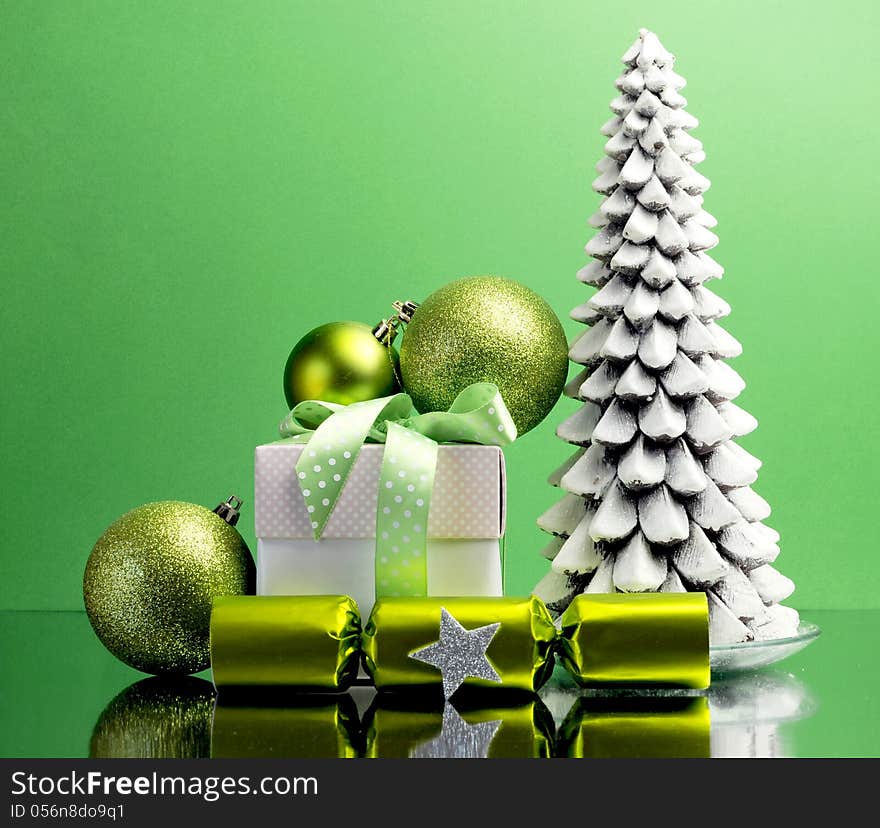 Green theme Christmas gift and bauble decorations festive holiday still life.