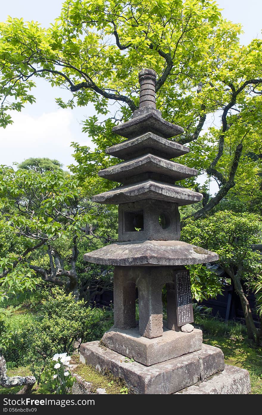 Ancient stone lantern inside summer zen garden. Ancient stone lantern inside summer zen garden