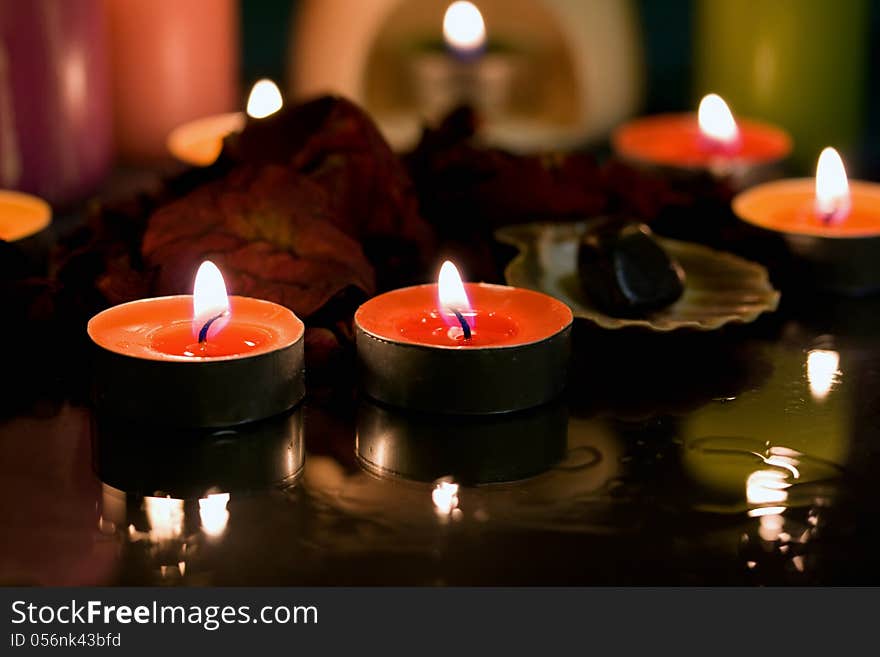 Spa candle with rose petals in water. Spa candle with rose petals in water