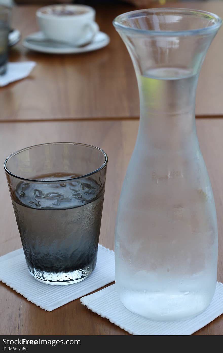 Glass iced and water bottle on table. Glass iced and water bottle on table