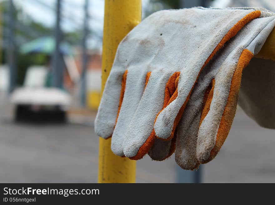 Glove work heavy duty leather on yellow scaffolding. Glove work heavy duty leather on yellow scaffolding