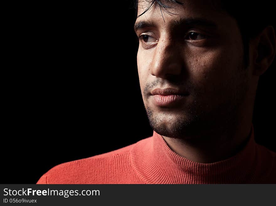 Portrait of young Indian  man over dark