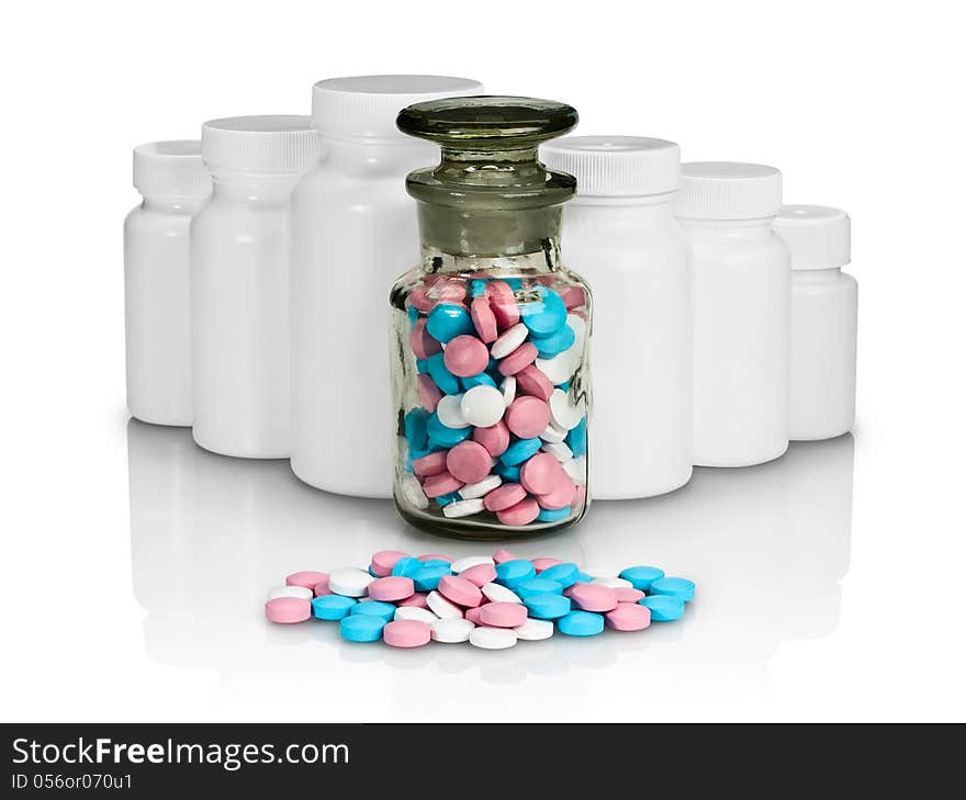 Pills, plastic small bottles and a glass vial on a white background. Pills, plastic small bottles and a glass vial on a white background