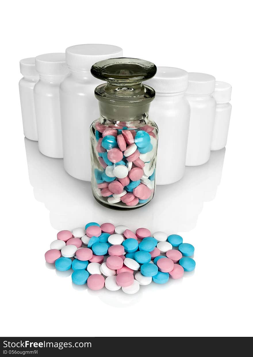 Pills, plastic small bottles and a glass vial on a white background. Pills, plastic small bottles and a glass vial on a white background