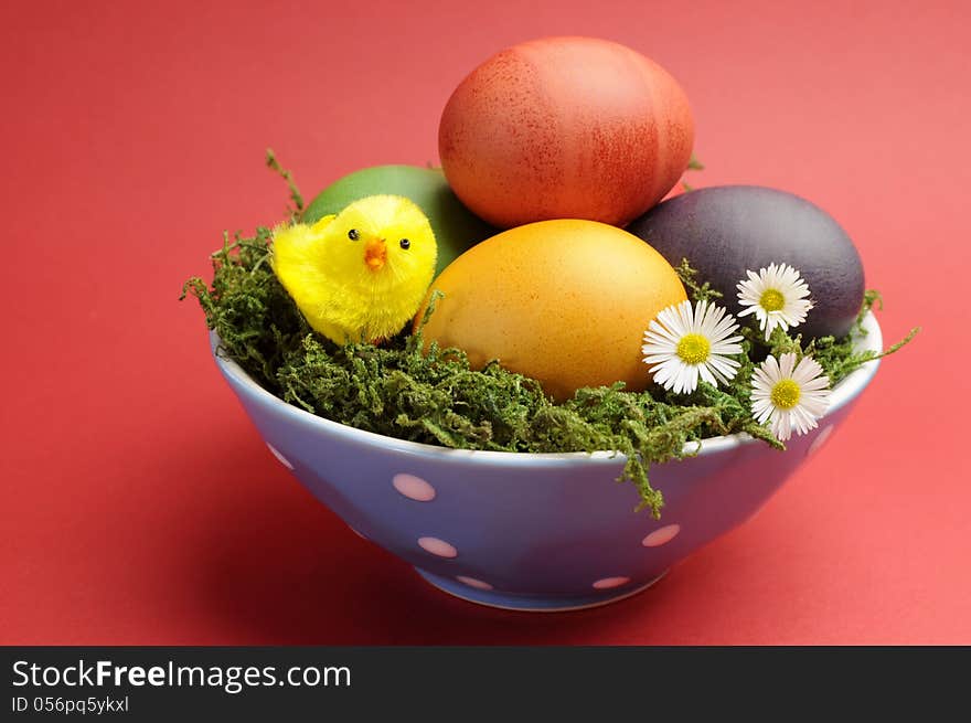 Happy Easter Still Life With Rainbow Color Eggs Against A Red Background.