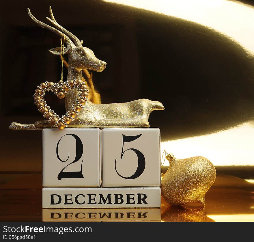 Gold theme Save the Date calendar for Christmas Day, December 25, with bauble and reindeer decorations. Gold theme Save the Date calendar for Christmas Day, December 25, with bauble and reindeer decorations.