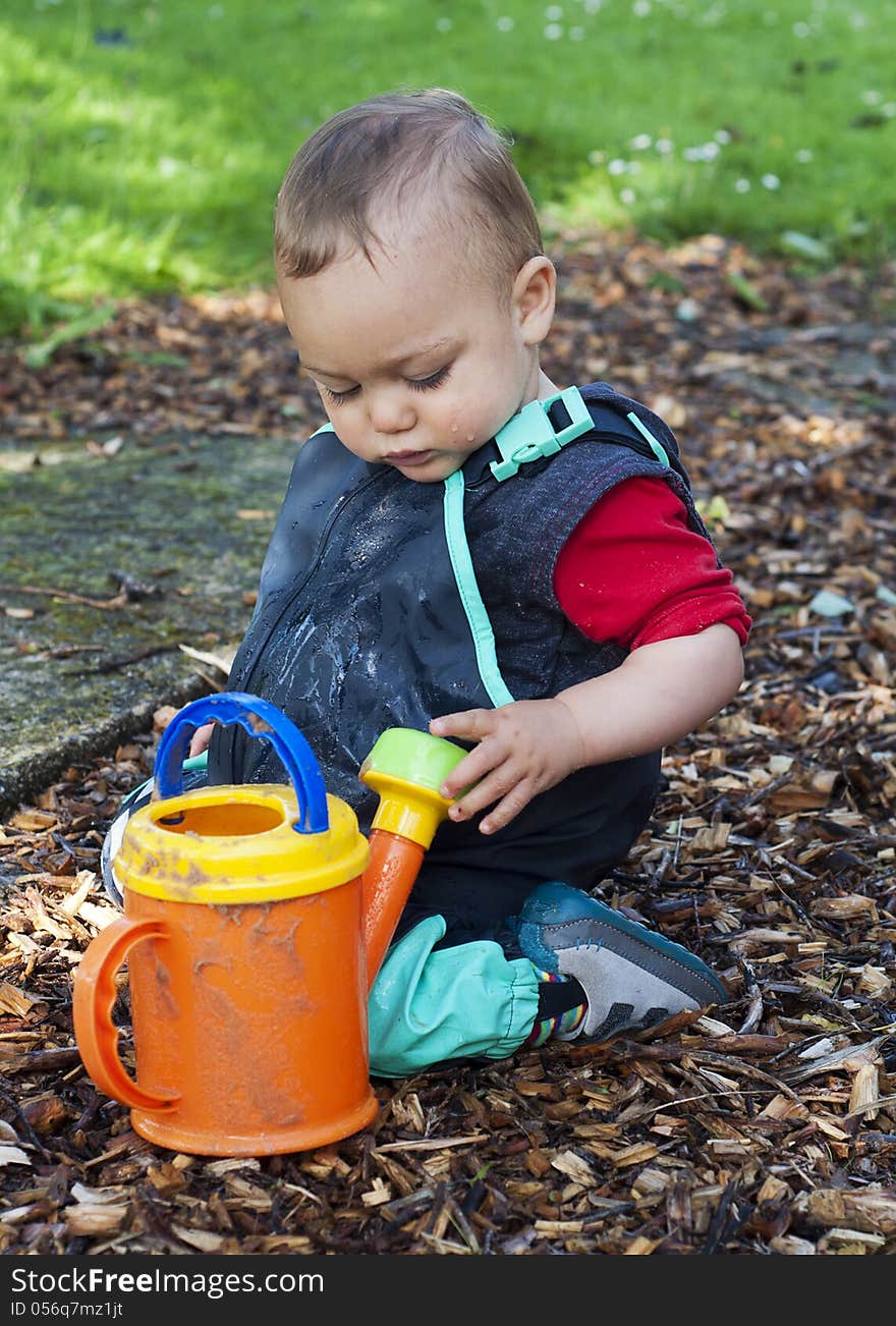 Child playing with watering can