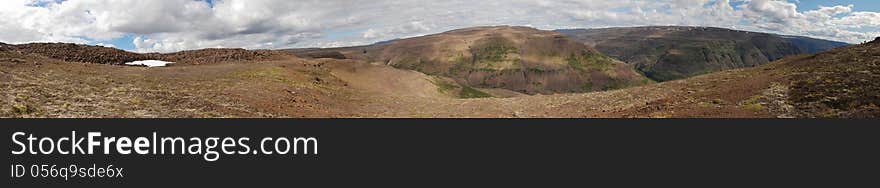 Panorama mountain landscape of the Putorana plateau. Russia, Taimyr Peninsula.