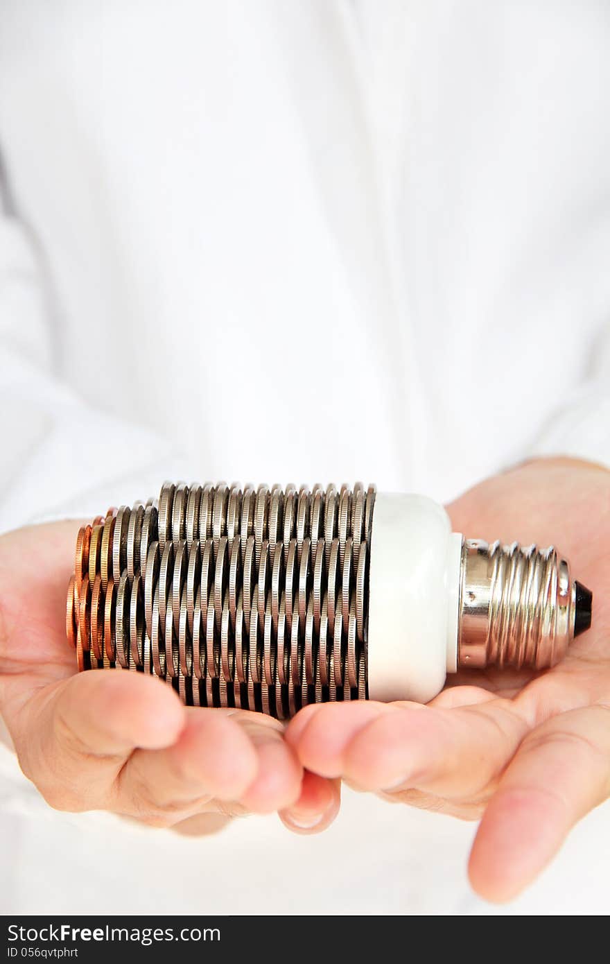 Hand holding coin light bulb concept