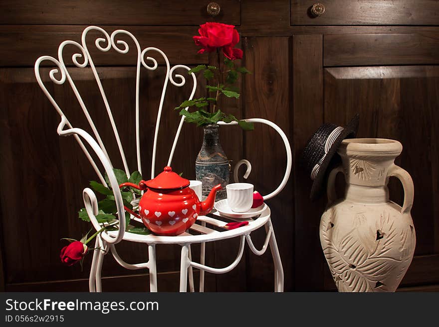 Still life with antique chair, flowers and tea