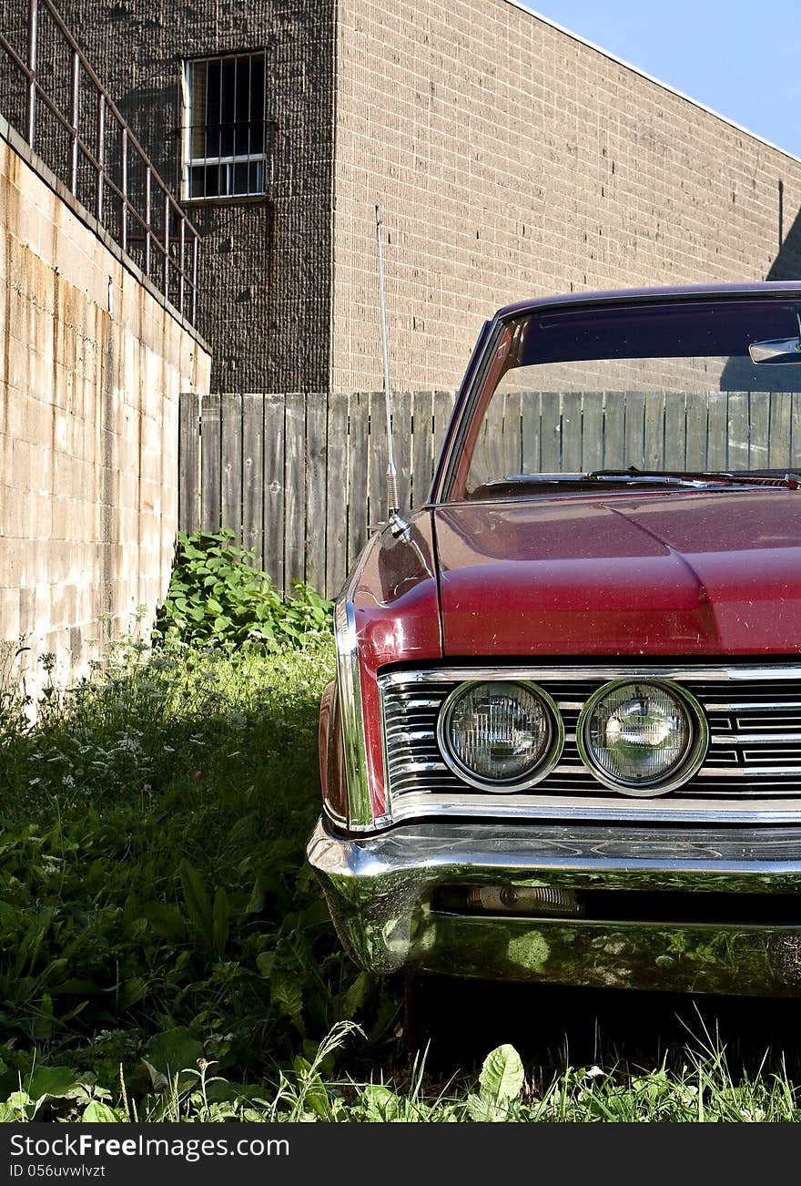 Front view of a red 1966 Chrysler Windsor &#x28;made in Canada, equivalent of the Chrysler Newport in the United States&#x29;.  Car parked on grass with concrete building in the background. Front view of a red 1966 Chrysler Windsor &#x28;made in Canada, equivalent of the Chrysler Newport in the United States&#x29;.  Car parked on grass with concrete building in the background.