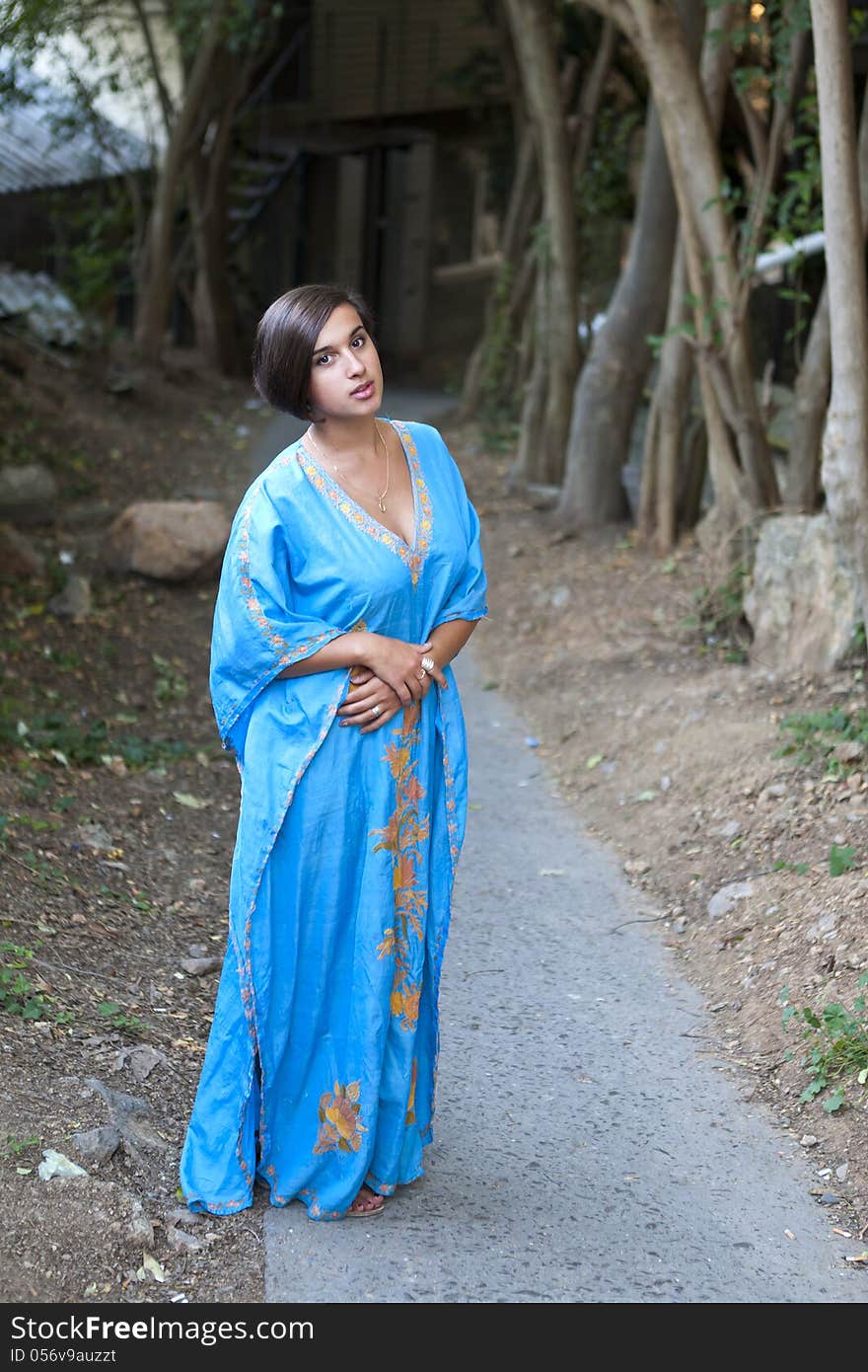 Girl in blue indian dress over dark alley