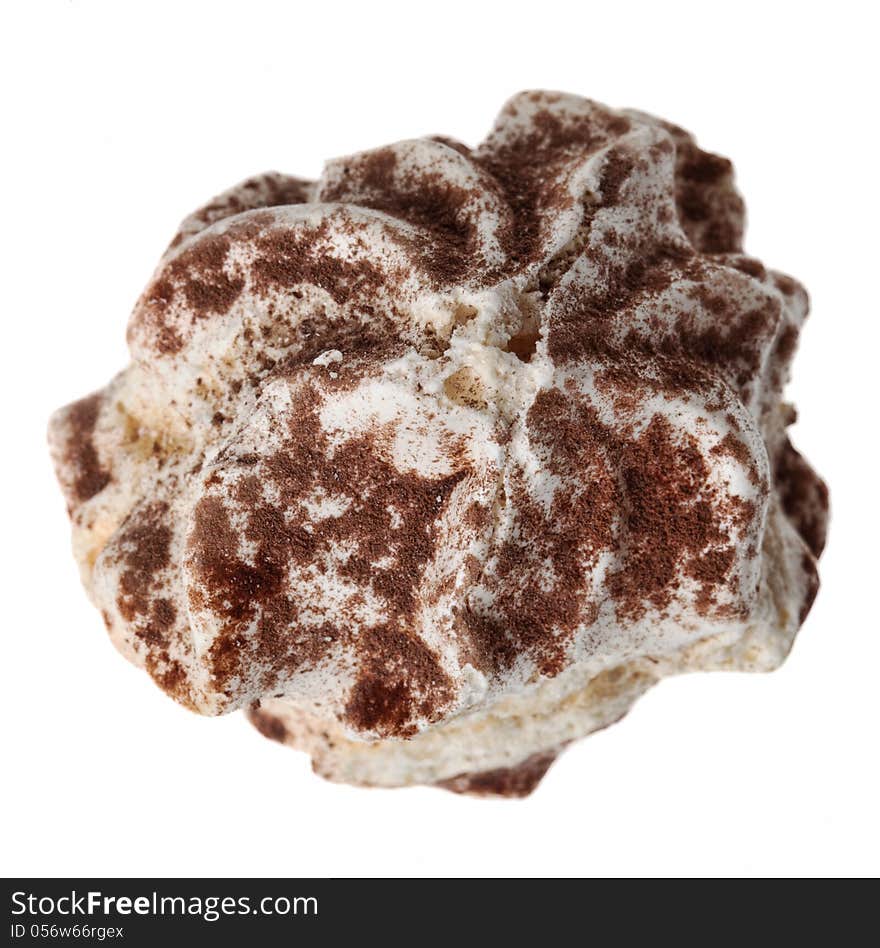 Upper view of a custard cake cover in cocoa powder isolated against a white background.