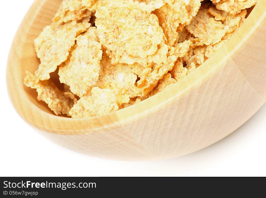 Flakes Breakfast Cereal in Wood Bowl closeup on white background