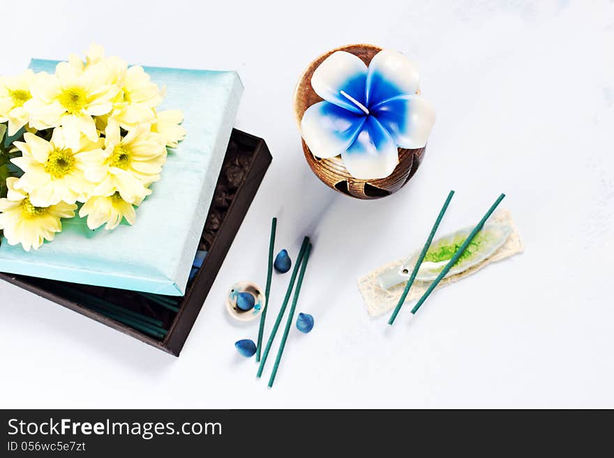 Aromatherapy set with flower candle and incense, selective focus