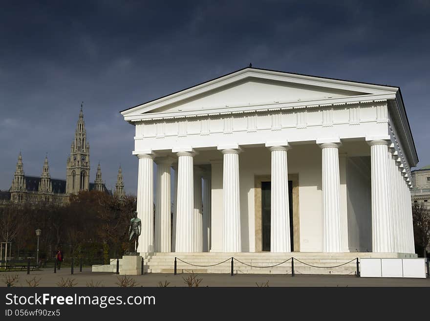 Bright sunlight on classical building in the Heldenplatz of Vienna with the Rathaus (town hall) away in the background. Bright sunlight on classical building in the Heldenplatz of Vienna with the Rathaus (town hall) away in the background