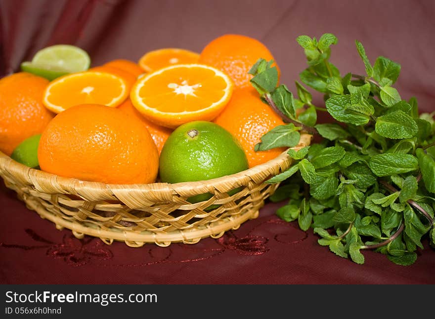 oranges and limes in a basket