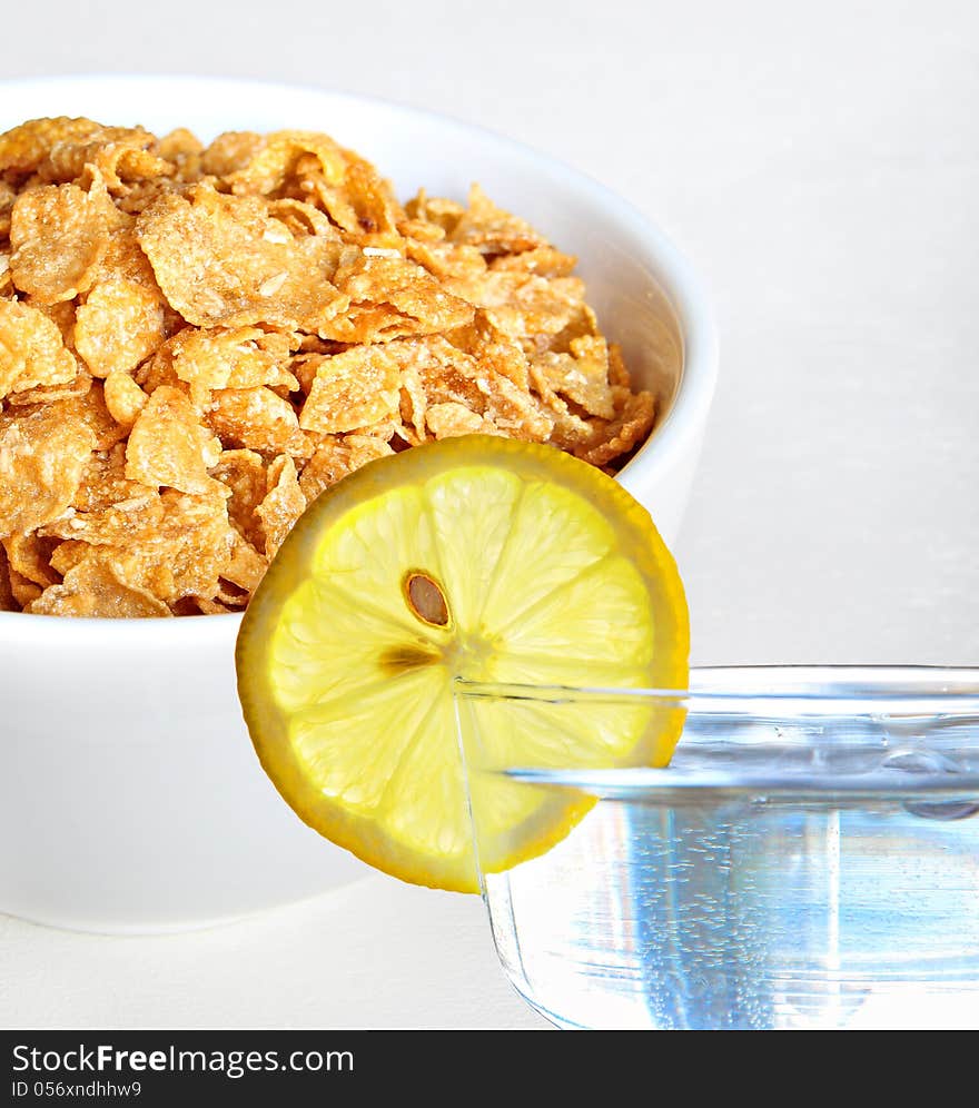 Photo showing bowl of healthy cereal and glass of water with slice of lemon!. Photo showing bowl of healthy cereal and glass of water with slice of lemon!