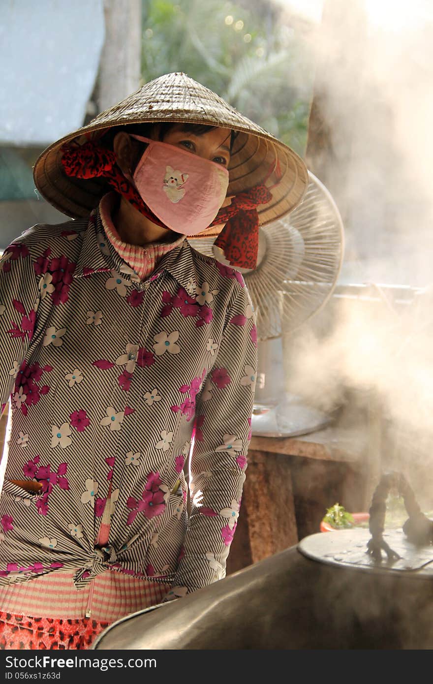 Vietnamese woman cooking food, Vietnam.