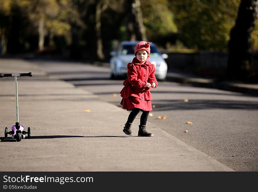 A girl on a footpath, running around. A girl on a footpath, running around.