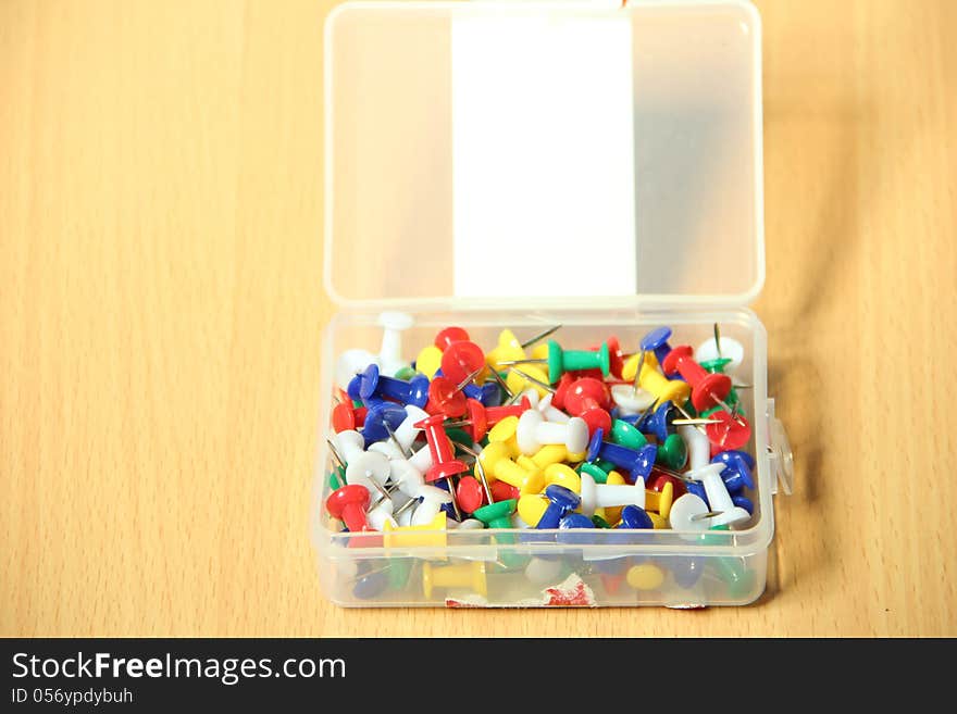 Colorful Straight pins on wooden table