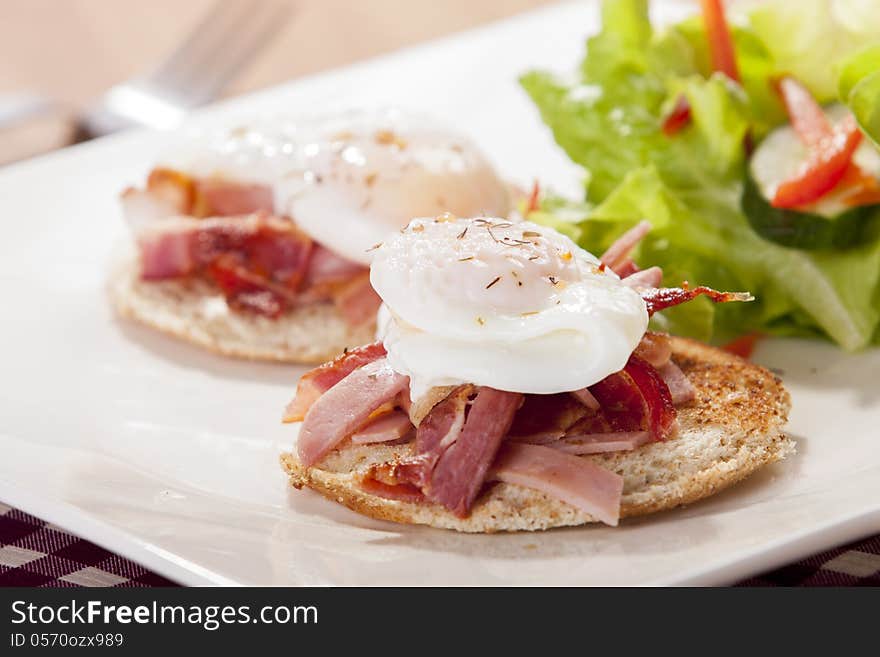 Poached egg on toast, with smoked bacon, and salad. Poached egg on toast, with smoked bacon, and salad