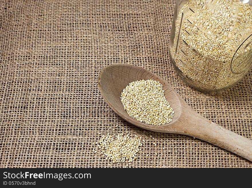 Quinoa And Wooden Spoon On Burlap Background-conce