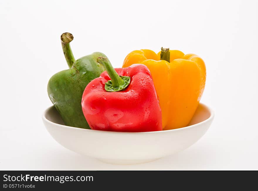 Red green yellow sweet peper on white bowl