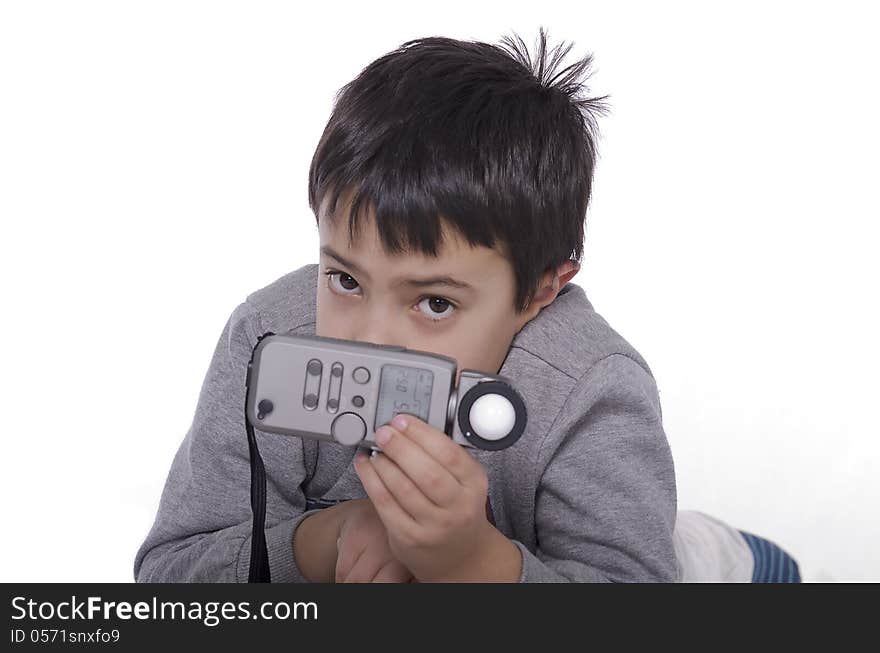 Portrait of a young child with a light meter to evaluate the light. Portrait of a young child with a light meter to evaluate the light.