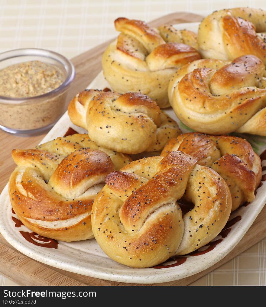 Soft pretzels on a platter with mustard dip