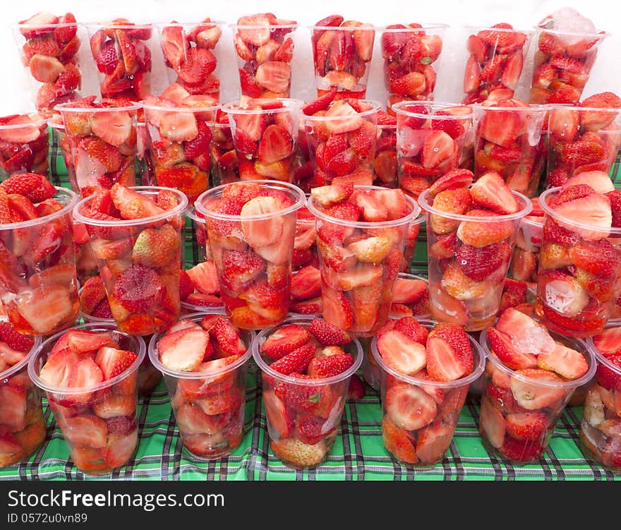 A half strawberry fruits in glass.