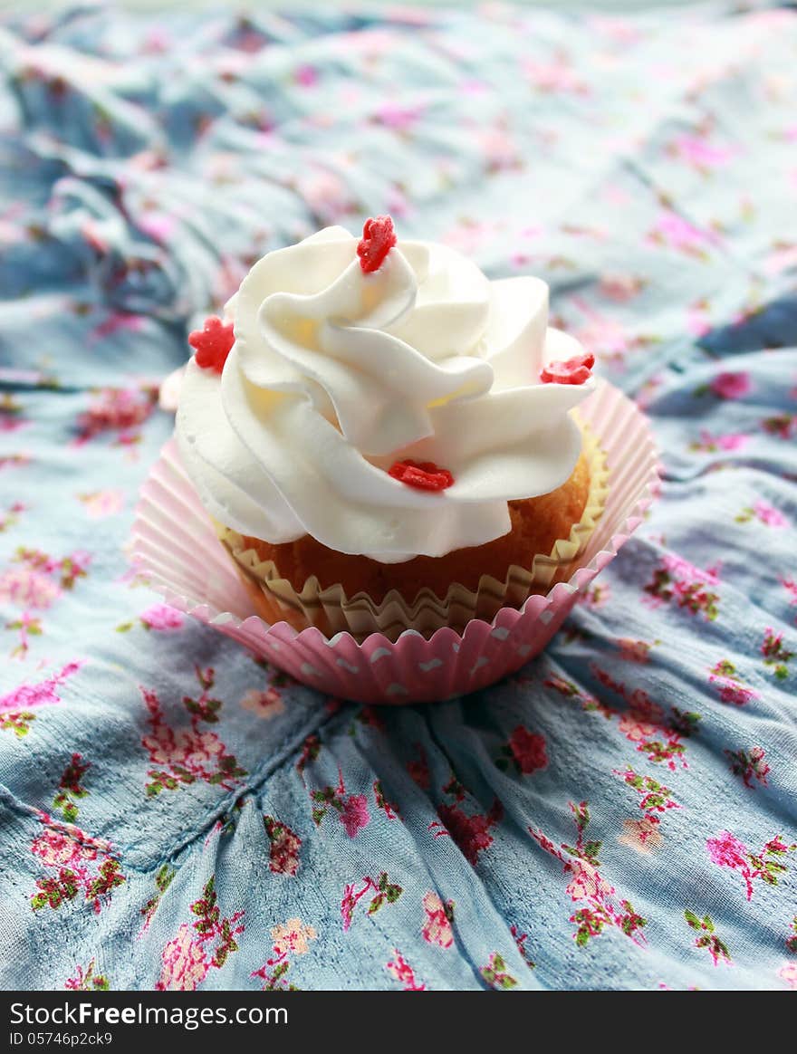 Vintage pink cupcake withe cream and fondant flower. Vintage pink cupcake withe cream and fondant flower