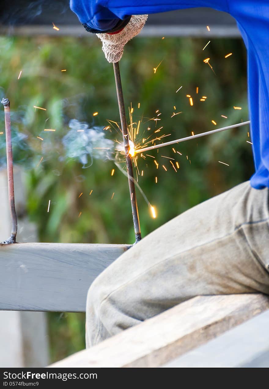 Welder welding elements at the construction site