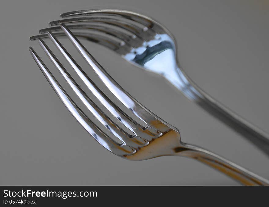 A fork located on a mirror. A fork located on a mirror