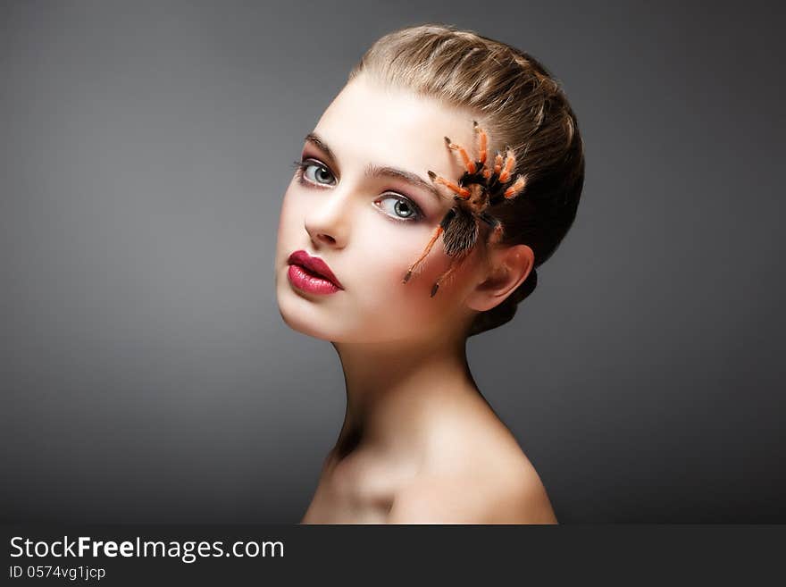 Portrait of Woman with brachypelma smithi Spider creeping on her Face