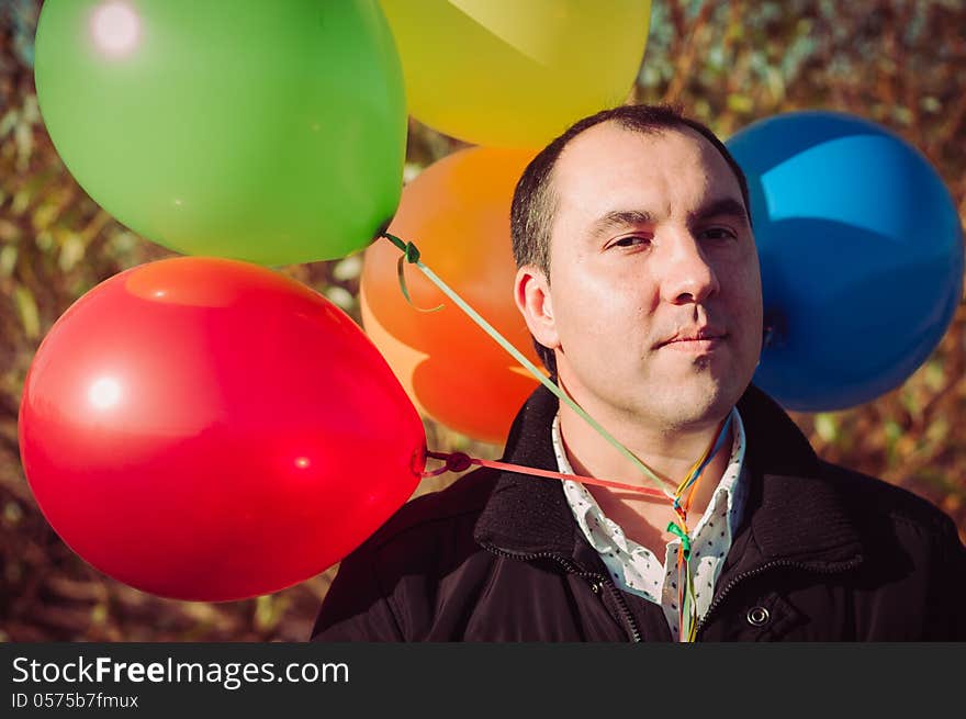 Young man with lot of balloons outdoor. Young man with lot of balloons outdoor