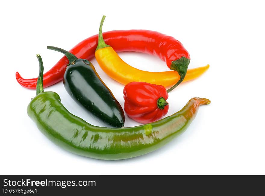 Arrangement of Various Chili Peppers with Red Habanero, Green Jalapeño, Yellow Santa Fee, Green and Red Peppers isolated on white background