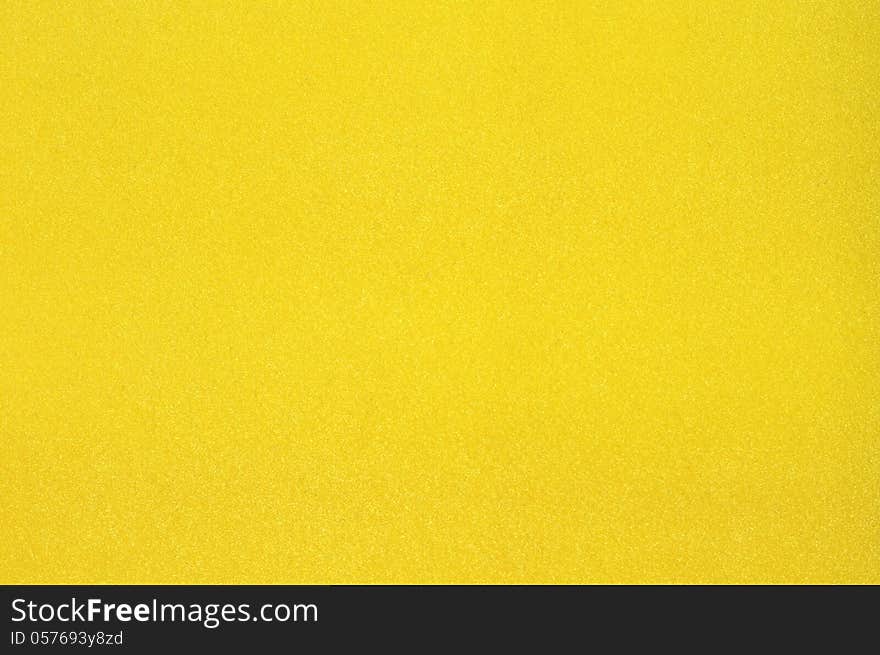 Texture of dense cardboard with yellow velvety coating. Texture of dense cardboard with yellow velvety coating