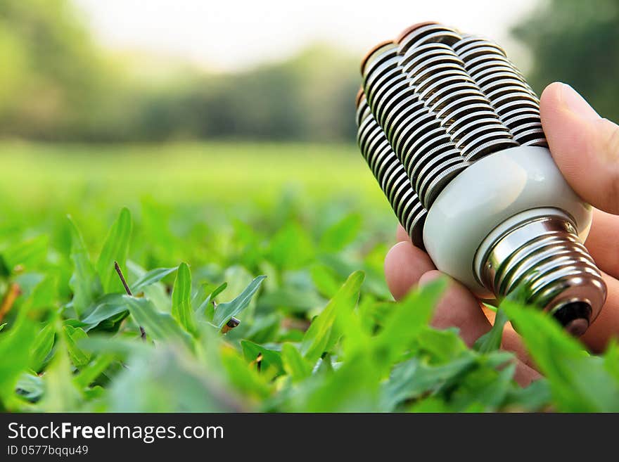 Hand holding coin light bulb,energy concept