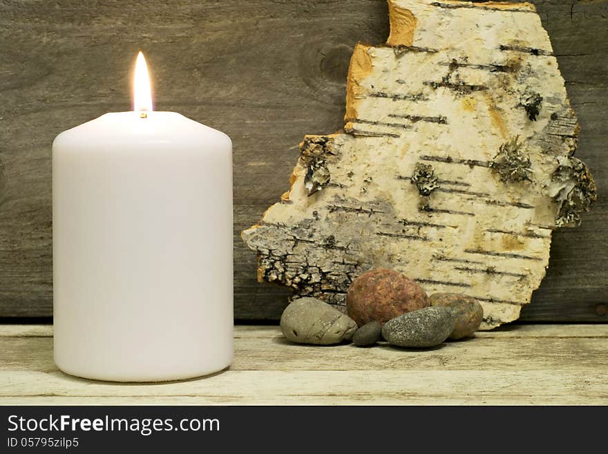 Candle, birch bark and stones