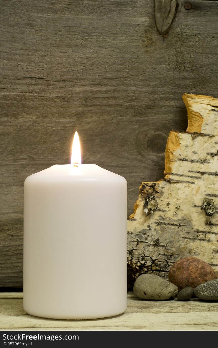 Candle, birch bark and stones