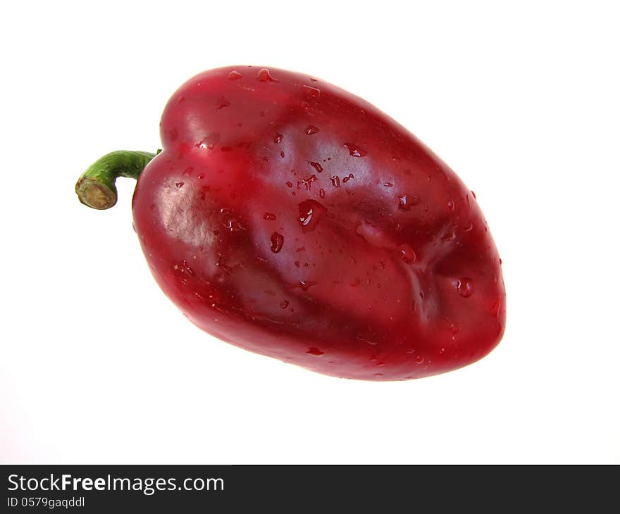 Big, red pepper with water drops isolated on a white background