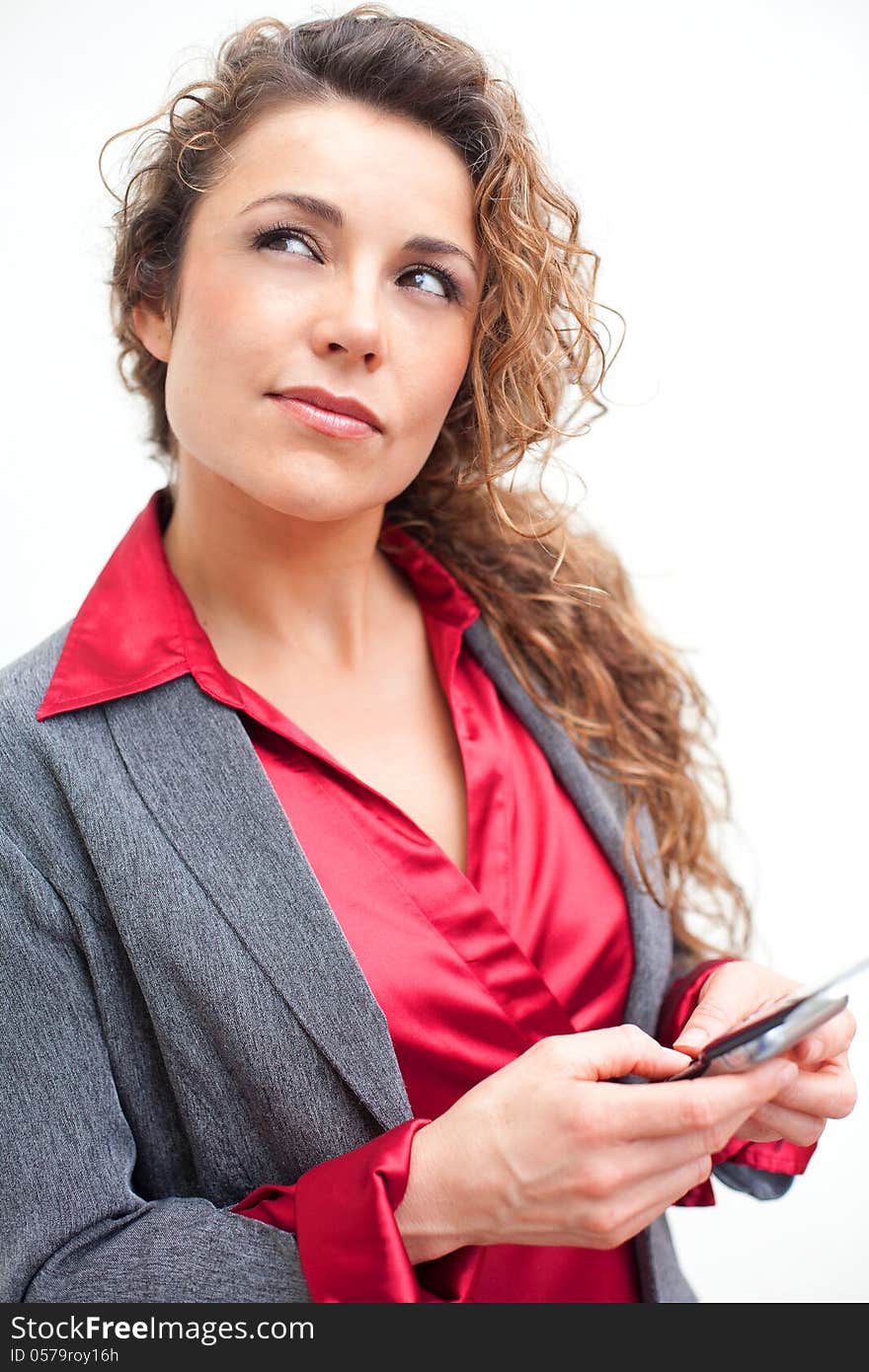 Beautiful business woman holding cellphone thinking about text messaging. Beautiful business woman holding cellphone thinking about text messaging.