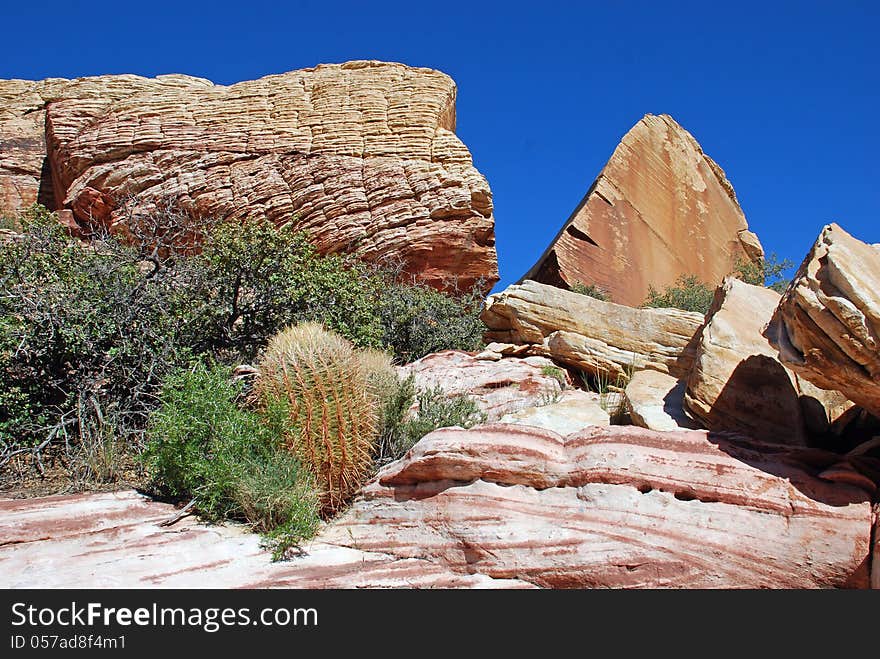 An interesting jumble of eroded sand stone rock formations near Red Rock Canyon, Southern Nevada. Sand stones are part of the Lower Jurassic geological formation called Aztec formation of 70+ million year old desert sediments. An interesting jumble of eroded sand stone rock formations near Red Rock Canyon, Southern Nevada. Sand stones are part of the Lower Jurassic geological formation called Aztec formation of 70+ million year old desert sediments