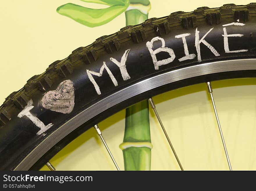 I love my bike phrase handwritten on the black wheel tire